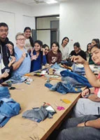 International faculty Ms. Maya leading denim felting workshop with design students
